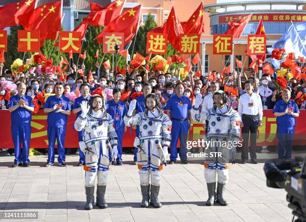 Chinese astronauts Cai Xuzhe , Chen Dong and Liu Yang pose during a ceremony prior to the launch at the Shenzhou-14 mission at the Jiuquan Satellite...