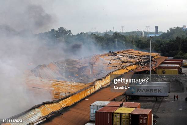 This picture taken on June 5, 2022 shows smoke billowing after a fire broke out at a container storage facility in Sitakunda, about 40 km from the...