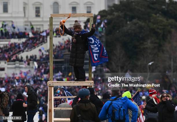 Woman poses for a picture with a noose during a protest calling for legislators to overturn the election results in President Donald Trump's favor at...