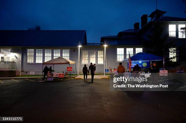 Members of both parties hand out campaign literature as voters make their way to the polls before dawn at Lucketts Community Center November 02, 2021...