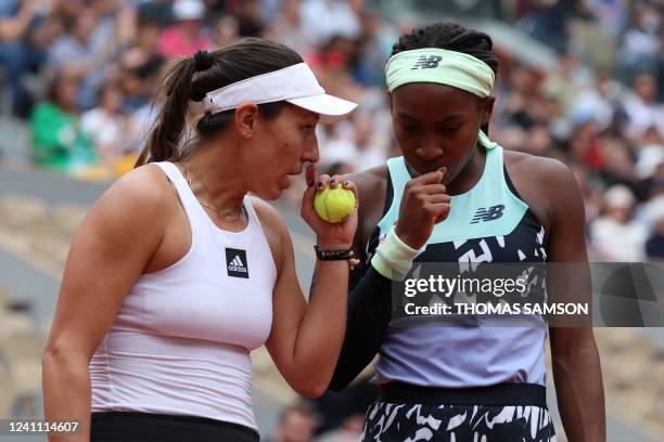 Jessica Pegula and US' Coco Gauff speak as they play against France's Kristina Mladenovic and France's Caroline Garcia during their women's doubles...