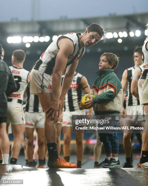 Scott Pendlebury of the Magpies and son Jax are seen during the 2022 AFL Round 12 match between the Hawthorn Hawks and the Collingwood Magpies at the...