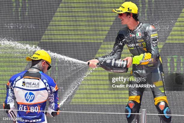 Winner Mooney VR46 Racing Team Italian rider Celestino Vietti celebrates on the podium with second placed HP40 Spanish rider Aron Canet after the...