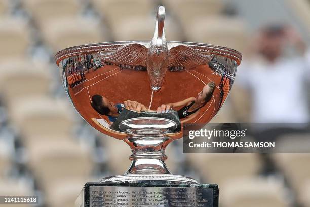 France's Caroline Garcia and France's Kristina Mladenovic are reflected in their trophy as they celebrate after victory over Coco Gauff and Jessica...