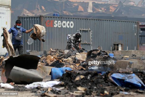 Officials inspect the site after a fire that broke out at a shipping container storage facility in Sitakunda, about 40 km from the key port of...