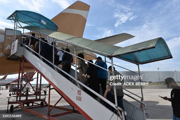 Passengers board an Airbus A320 operated by Indonesia's latest airline Super Air Jet, which began operations last year, in Medan, North Sumatra on...