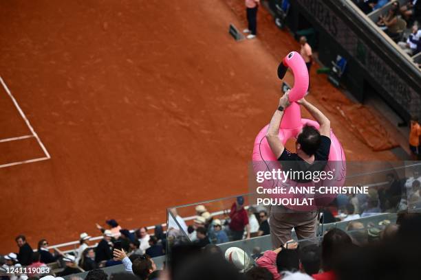 Spectator with a flamingo buoy is pictured during the men's singles final match between Spain's Rafael Nadal and Norway's Casper Ruud on day fifteen...