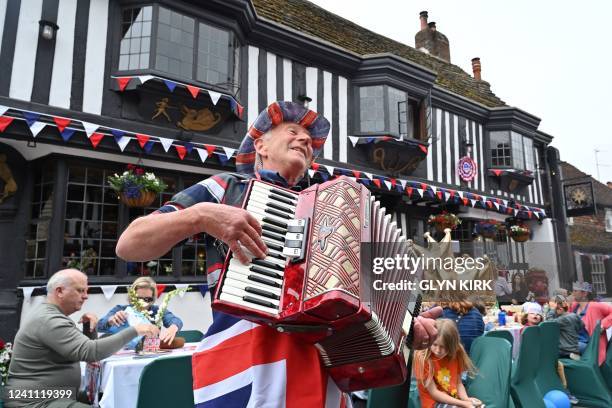 An accordionist performs during a street party in Alfriston, East Sussex, on June 5, 2022 as part of Queen Elizabeth II's platinum jubilee...