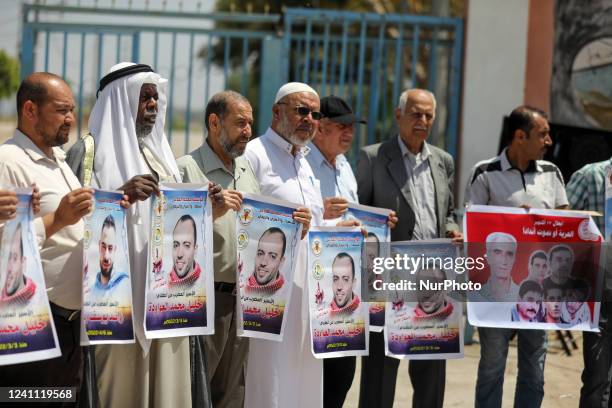 Palestinians take part in a protest in solidarity with prisoners in Israeli jails, in front of the Erez Crossing in Beit Hanoun in the northern Gaza...