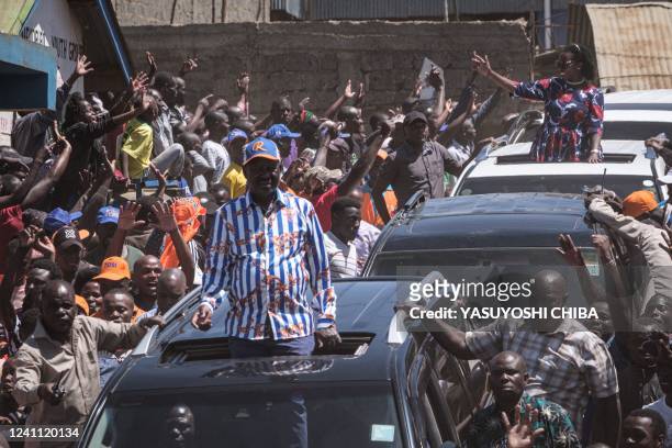 Azimio la Umoja coalition party's Raila Odinga and his running mate Martha Karua react to supporters during their rally after being officially...