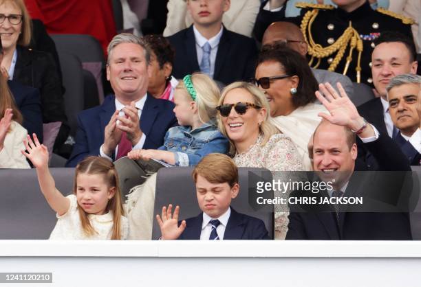 Britain's Princess Charlotte of Cambridge, Britain's Prince George of Cambridge and Britain's Prince William, Duke of Cambridge, wave as they attend...