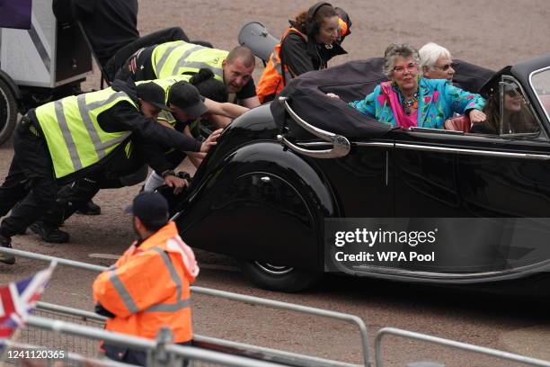 People push a classic car carrying The Great British Bake Off judge Prue Leith after it broke down during the Platinum Jubilee Pageant in front of...