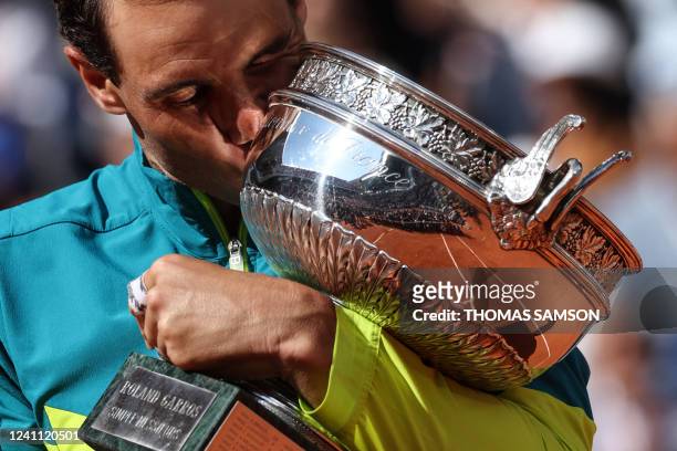 Spain's Rafael Nadal celebrates with the trophy after winning against Norway's Casper Ruud at the end of their men's singles final match on day...