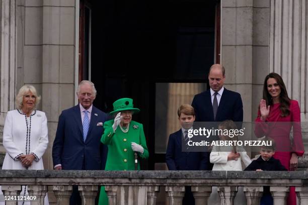 Britain's Queen Elizabeth II waves to the crowd as she stands on Buckingham Palace balcony with Britain's Camilla, Duchess of Cornwall, Britain's...