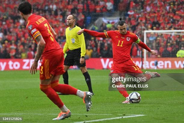 Wales' striker Gareth Bale shoots and scores a free kick to open the score during the FIFA World Cup 2022 play-off final qualifier football match...