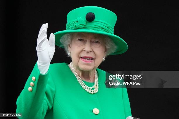 Queen Elizabeth II stands on the balcony during on June 05, 2022 in London, England. The Platinum Jubilee of Elizabeth II is being celebrated from...