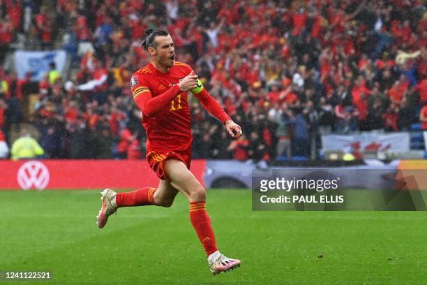 Wales' striker Gareth Bale celebrates after scoring the opening goal during the FIFA World Cup 2022 play-off final qualifier football match between...