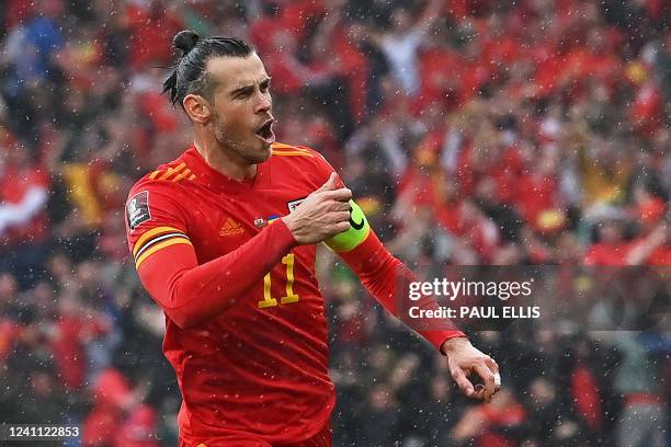 Wales' striker Gareth Bale celebrates after hitting a free kick and Ukraine scoring an own goal opening the score during the FIFA World Cup 2022...