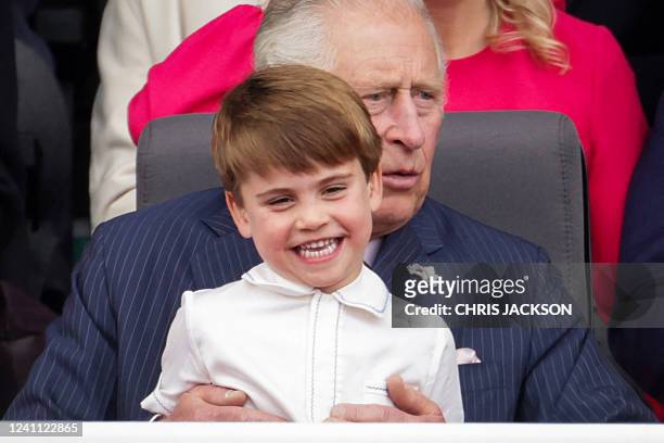 Britain's Prince Charles, Prince of Wales sits Britain's Prince Louis of Cambridge on his knee during the Platinum Pageant in London on June 5, 2022...