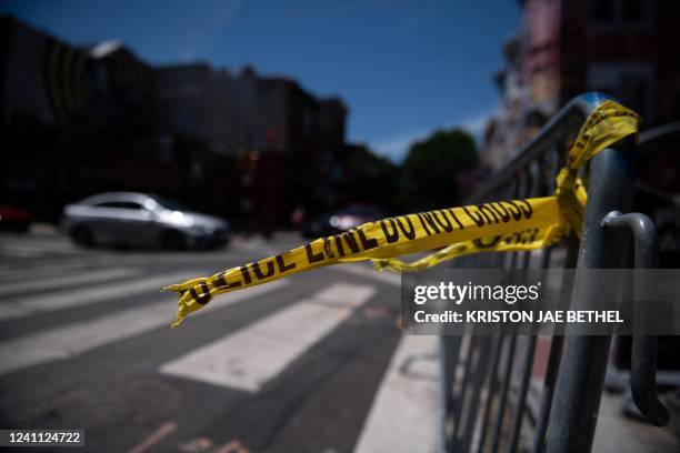 Police tape hangs from a barricade at the corner of South and 3rd Streets in Philadelphia, Pennsylvania, on June 5 the day after three people were...