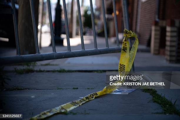Police tape hangs from a barricade at the corner of Lombard and 4th Streets in Philadelphia, Pennsylvania, on June 5 the day after gunfire left three...