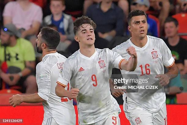 Spain's midfielder Pablo Gavi celebrates scoring the 1-1 goal with Spain's midfielder Rodrigo Hernandez and Spain's defender Dani Carvajal during the...