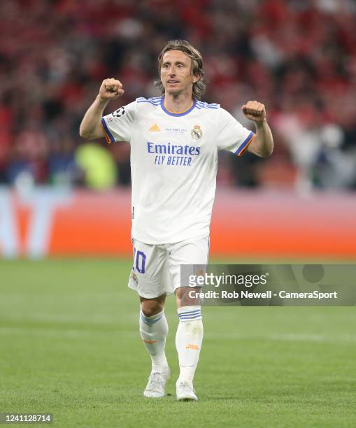 Real Madrids Luka Modric celebrates his sides first goal scored by Vinicius Junior with the trophy during the UEFA Champions League final match...