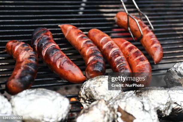 Sausages are seen preparing on a grill in Dobczyce, Poland on June 4, 2022.