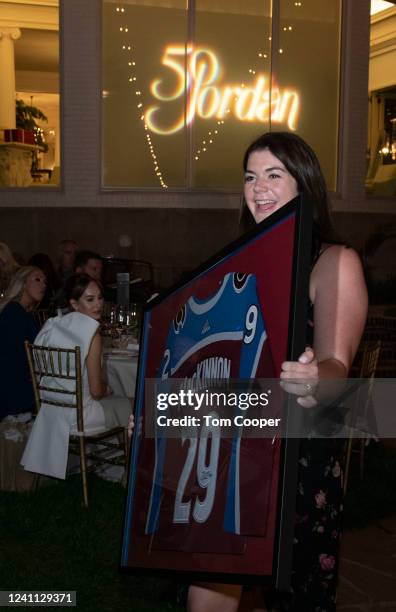 Jordan Vineyard & Winery winemaker Maggie Kruse parades Colorado Avalanche jersey to show guests. It was auctioned off live at the Jordan Vineyard &...