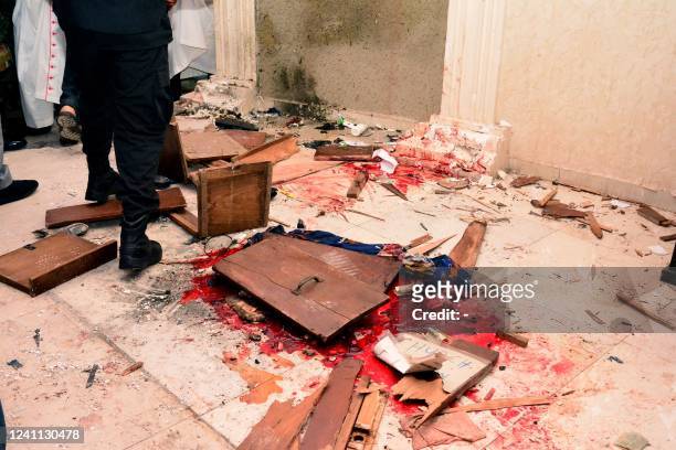 Graphic content / A man walk past the blood the stained floor after an attack by gunmen at St. Francis Catholic Church in Owo town, southwest Nigeria...