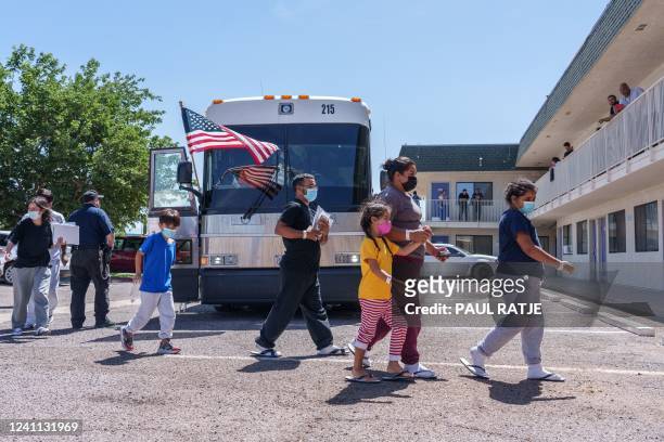 Families from Latin America arrive at a motel being used as a shelter run by the non-profit Colores United, after being released from immigration...