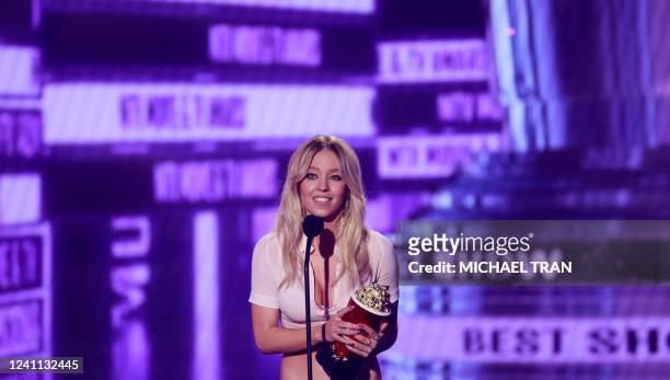 Actress Sydney Sweeney accepts the MTV award for Best Show "Euphoria" on stage during the MTV Movie and TV Awards at the Barker Hangar in Santa...