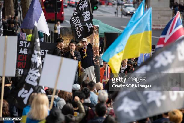 Nathan Law, an activist in exile and former member of the Legislative Council in Hong Kong speaks during the rally outside Downing Street against...