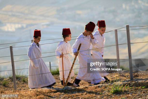 Members of the ancient Samaritan community parade during the Shavuot holiday on Mount Gerizim near the West Bank city of Nablus. The Samaritans...