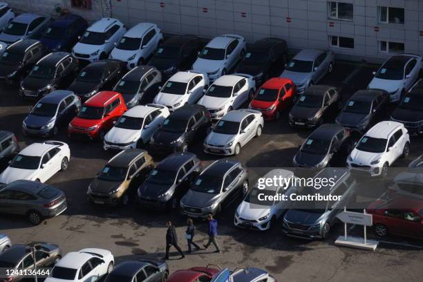 Shoppers examine second hand cars at the store of used automobiles, June 5, 2022 in Moscow, Russia. French automobile manufacturer Renault sold its...