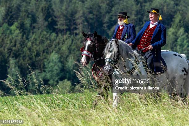 June 2022, Bavaria, Bad Kötzting: Participants of the Kötztinger Pfingstritt ride with their horses on a road. The procession is one of the oldest...