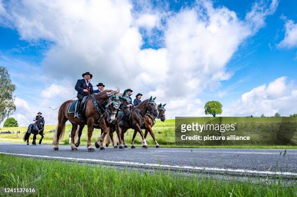 June 2022, Bavaria, Bad Kötzting: Participants of the Kötztinger Pfingstritt ride with their horses on a road. The procession is one of the oldest...