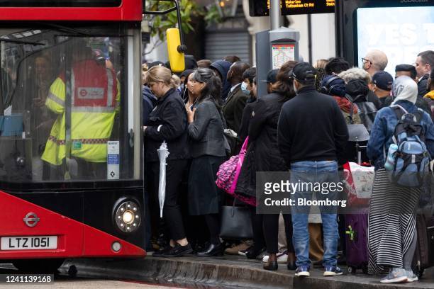 Commuters board a bus at a bus stop, during strikes on the underground rail service, in London, UK, on Monday, June 6, 2022. Commuters returning to...