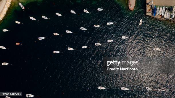 Drone view of boats in Assenza, Brenzone sul Garda at Lake Garda. The small island of Trimelone was used to be a military deposit during the First...