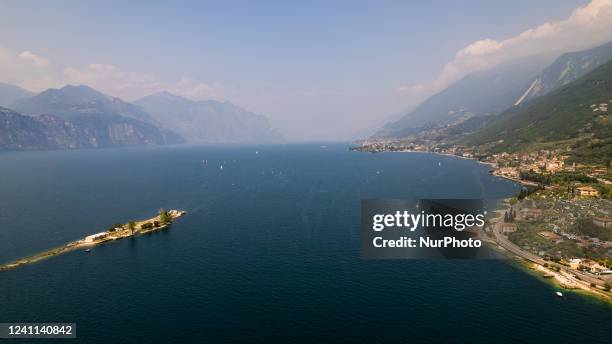 Drone view of Assenza, Brenzone sul Garda at Lake Garda. The small island of Trimelone was used to be a military deposit during the First and Second...