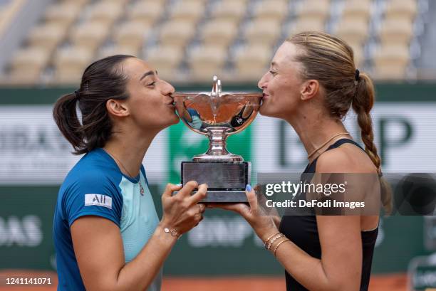 Caroline GARCIA of France and Kristina MLADENOVIC of France celebrate their victory kissing the trophy after the women's double final, on day fifteen...