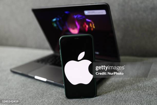 Apple website displayed on a laptop screen and Apple logo displayed on a phone screen are seen in this illustration photo taken in Krakow, Poland on...