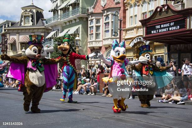 Disney film characters wave to park guest during the Festival of Fantasy parade at the Magic Kingdom Park at Walt Disney World in Orange County,...