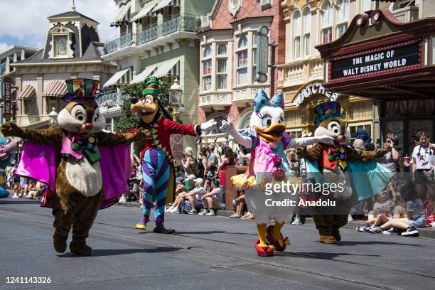 Disney film characters wave to park guest during the Festival of Fantasy parade at the Magic Kingdom Park at Walt Disney World in Orange County,...