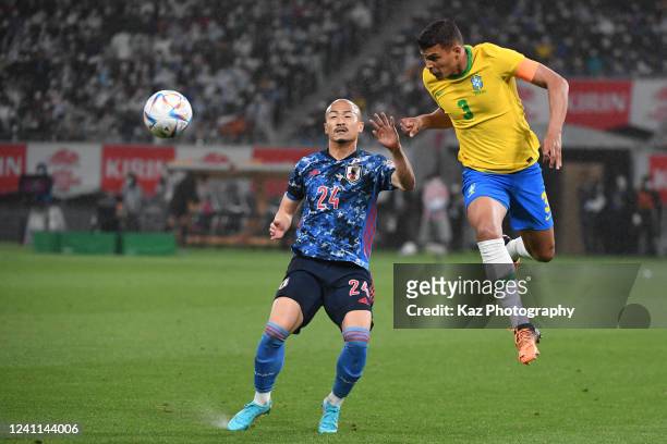 Thiago Silva of Brazil wins the header over Daizen Maeda of Japan during the international friendly match between Japan and Brazil at National...