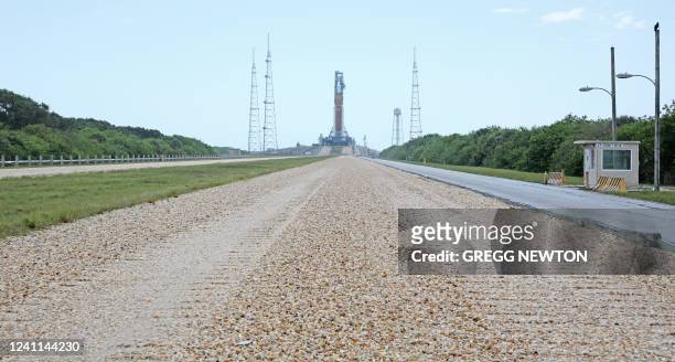 View from the crewler-way of the massive Artemis I Space Launch System rocket and Orion spacecraft at Launch Pad 39B after rolling out from the...