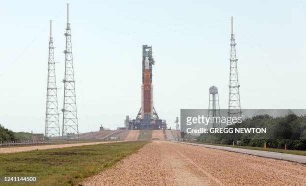 View from the crewler-way of the massive Artemis I Space Launch System rocket and Orion spacecraft at Launch Pad 39B after rolling out from the...