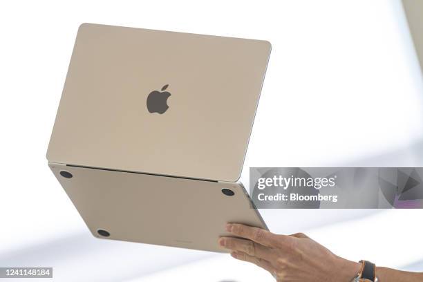 An attendee holds up a new MacBook Air laptop computer during the Apple Worldwide Developers Conference in Cupertino, California, US, on Monday, June...