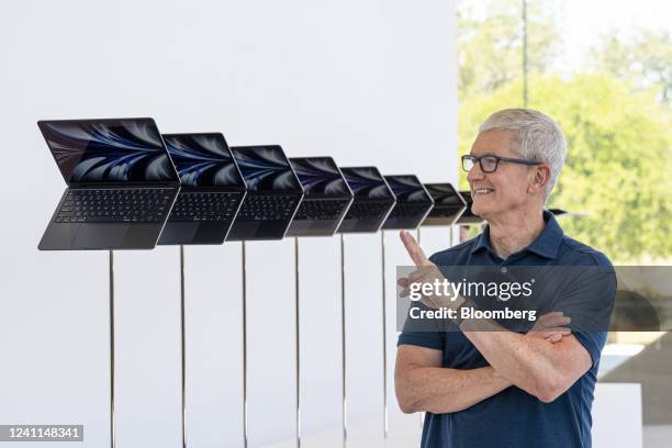 Tim Cook, chief executive officer of Apple Inc., next to a display of the new MacBook Air laptop computer during the Apple Worldwide Developers...
