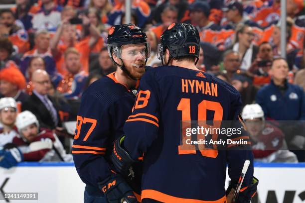 Connor McDavid#97 and Zach Hyman of the Edmonton Oilers discuss the play during Game Four of the Western Conference Finals of the 2022 Stanley Cup...